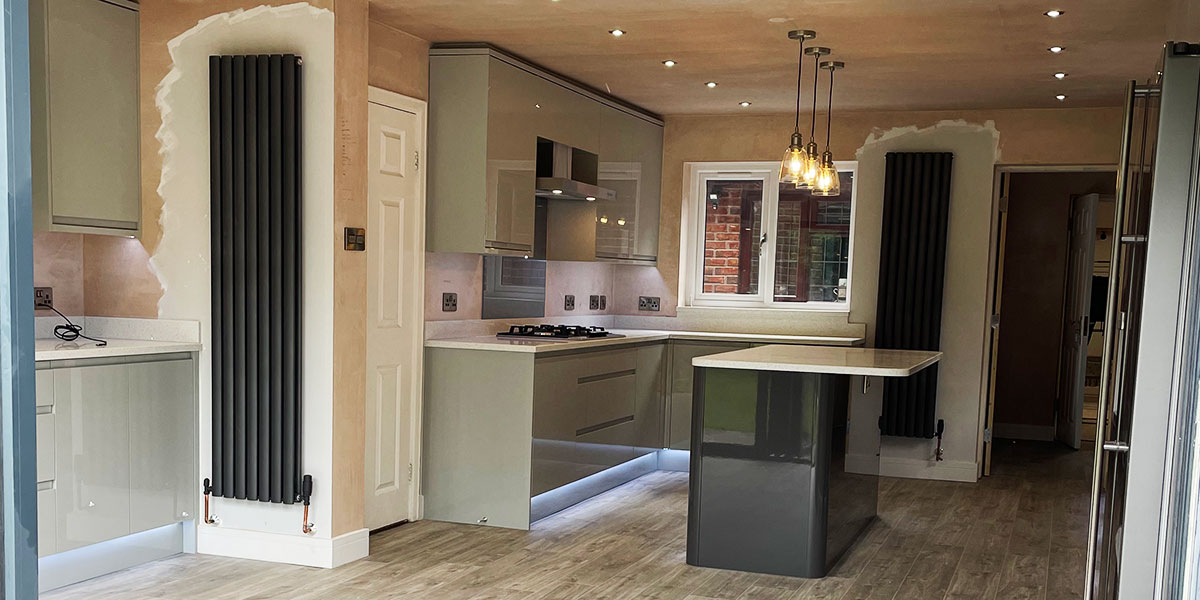 Grey gloss fitted kitchen installed by MW Construction in Hiderstone, near Stone