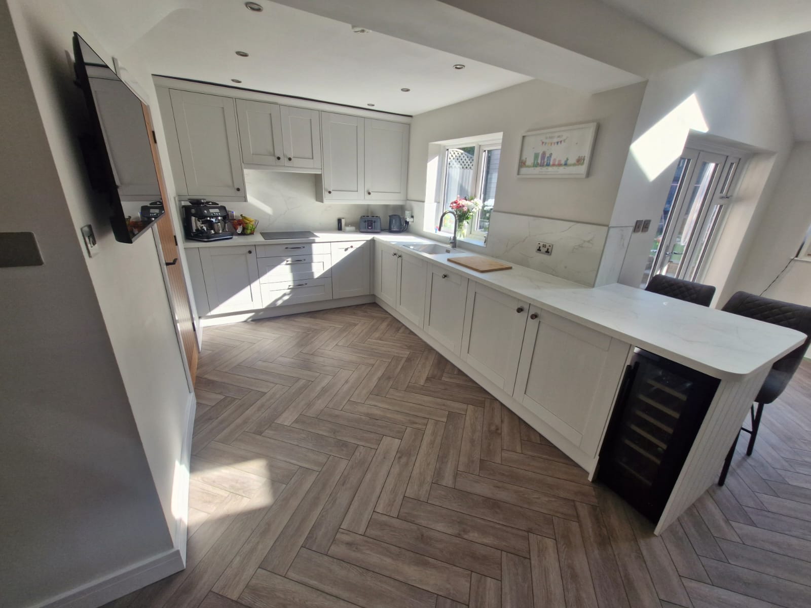 Completed kitchen The completed kitchen with the grey units, stunning flooring and new windows - all of the work done by MW Construction